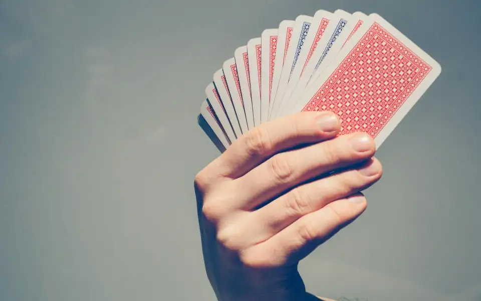 Hand fanning playing cards, representing tongits, pusoy and other card games on 218PLUSPH