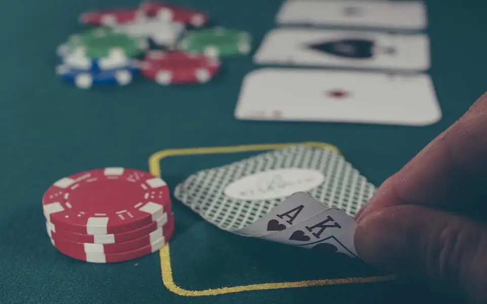 Chips and cards on a felt table, typical of 218PLUSPH live casino games